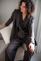 Modern tweed suit for women. Brown double-breasted blazer, waistcoat, and tapered-leg trousers.