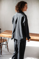 Loose-fitting minimalist wool shirt paired with a pair of black trousers. Ideal for office and special occasions.
