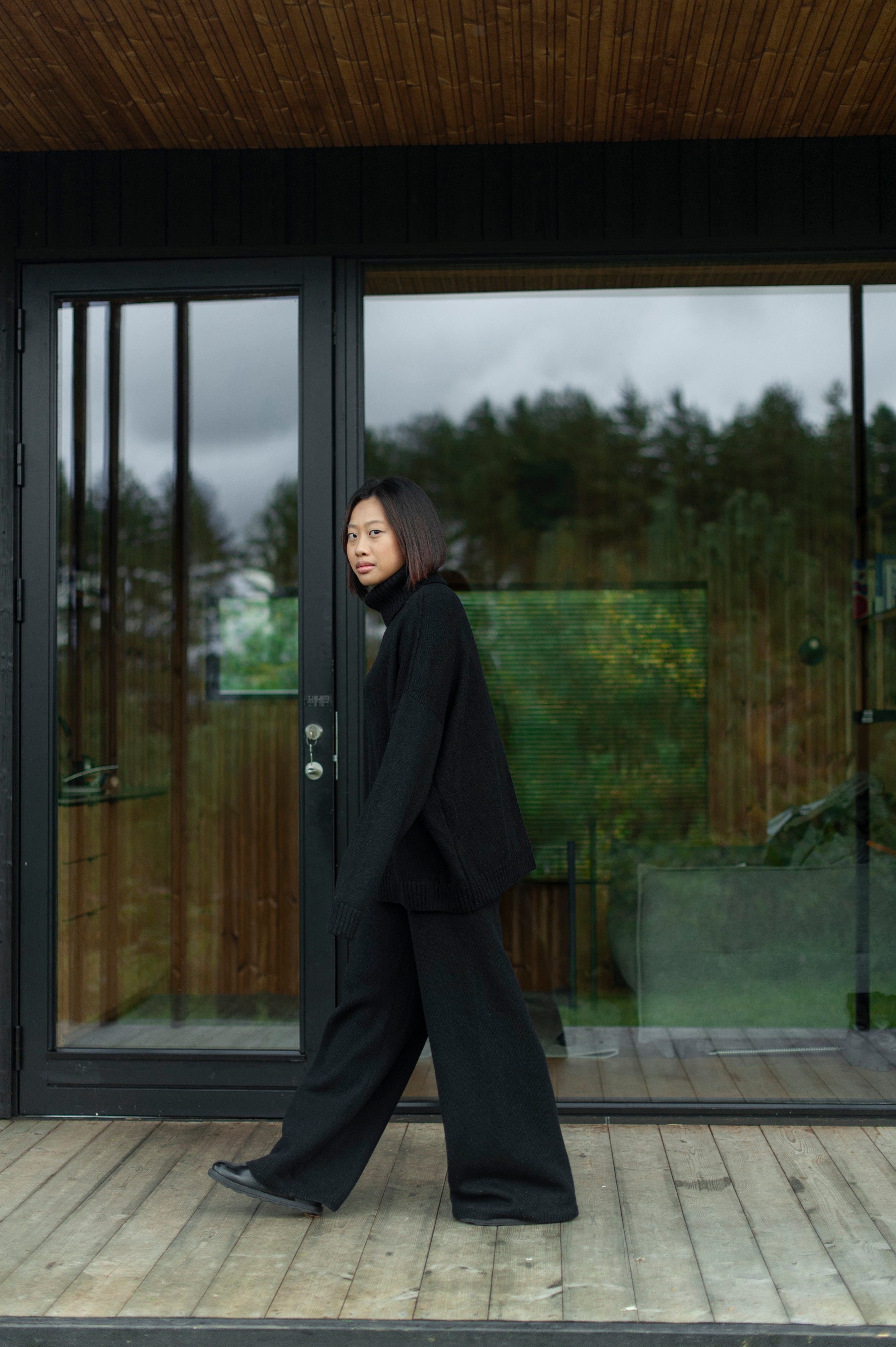 Minimalist oversized merino wool turtleneck jumper paired with matching color wide-leg pants. 