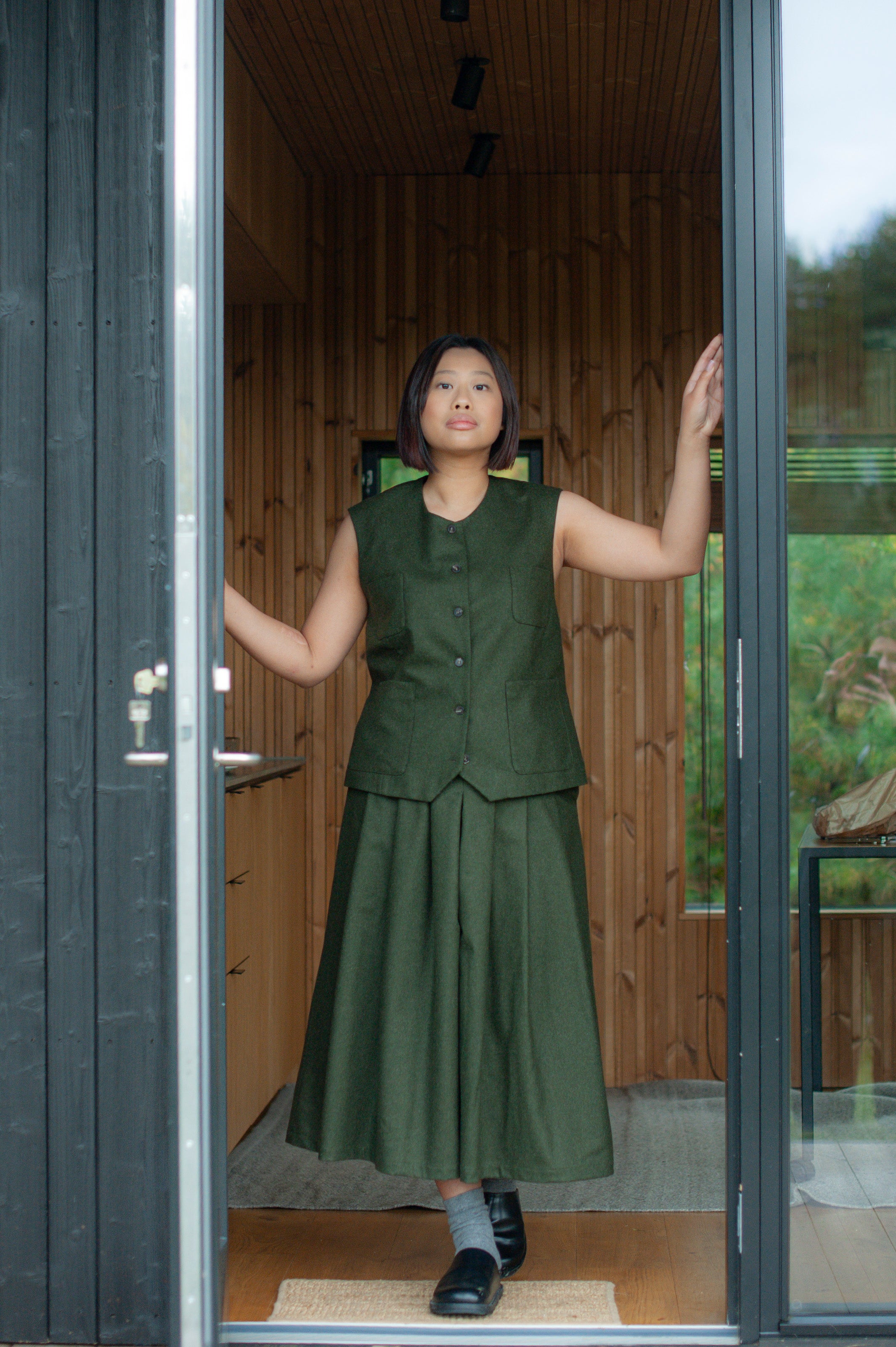 Mid-calf length culotte pants paired with a minimalist matching color button-up vest.