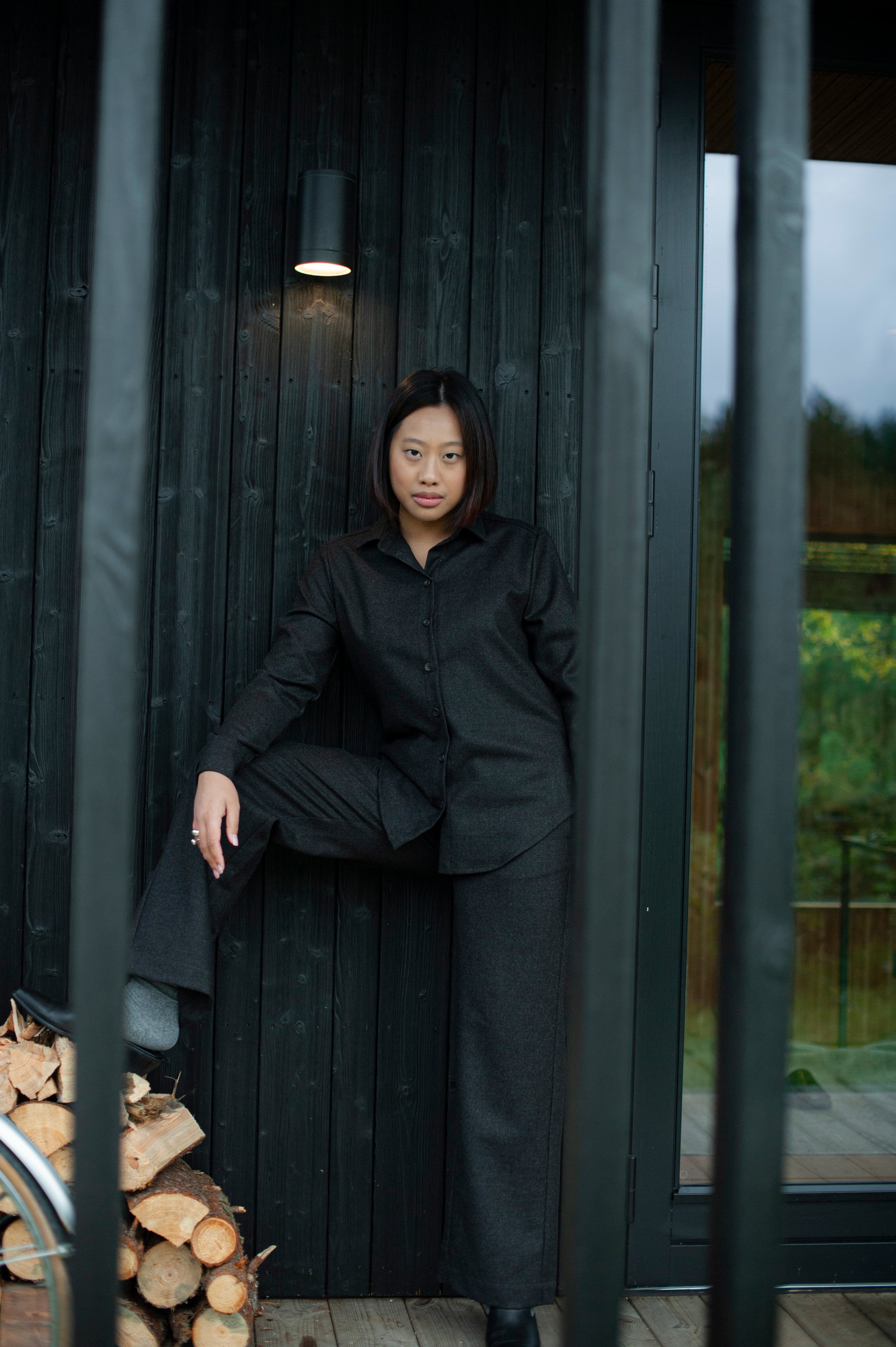 Women’s brown wool Oxford shirt with a relaxed straight fit and regular collar, paired with matching brown straight-leg pants for a minimalist, elegant look.