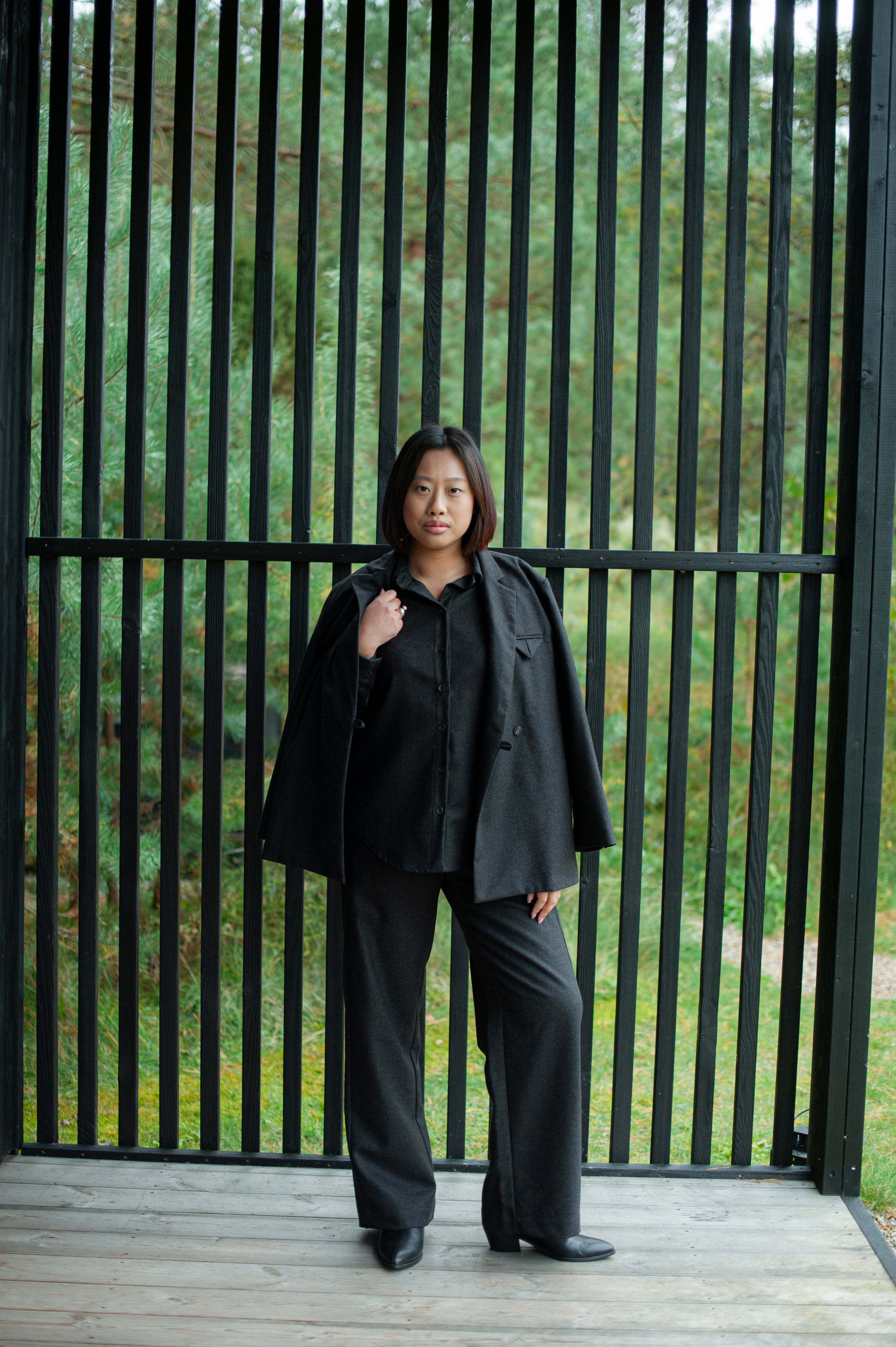 Brown wool trousers paired with a matching button-up shirt and a boxy cut  blazer.