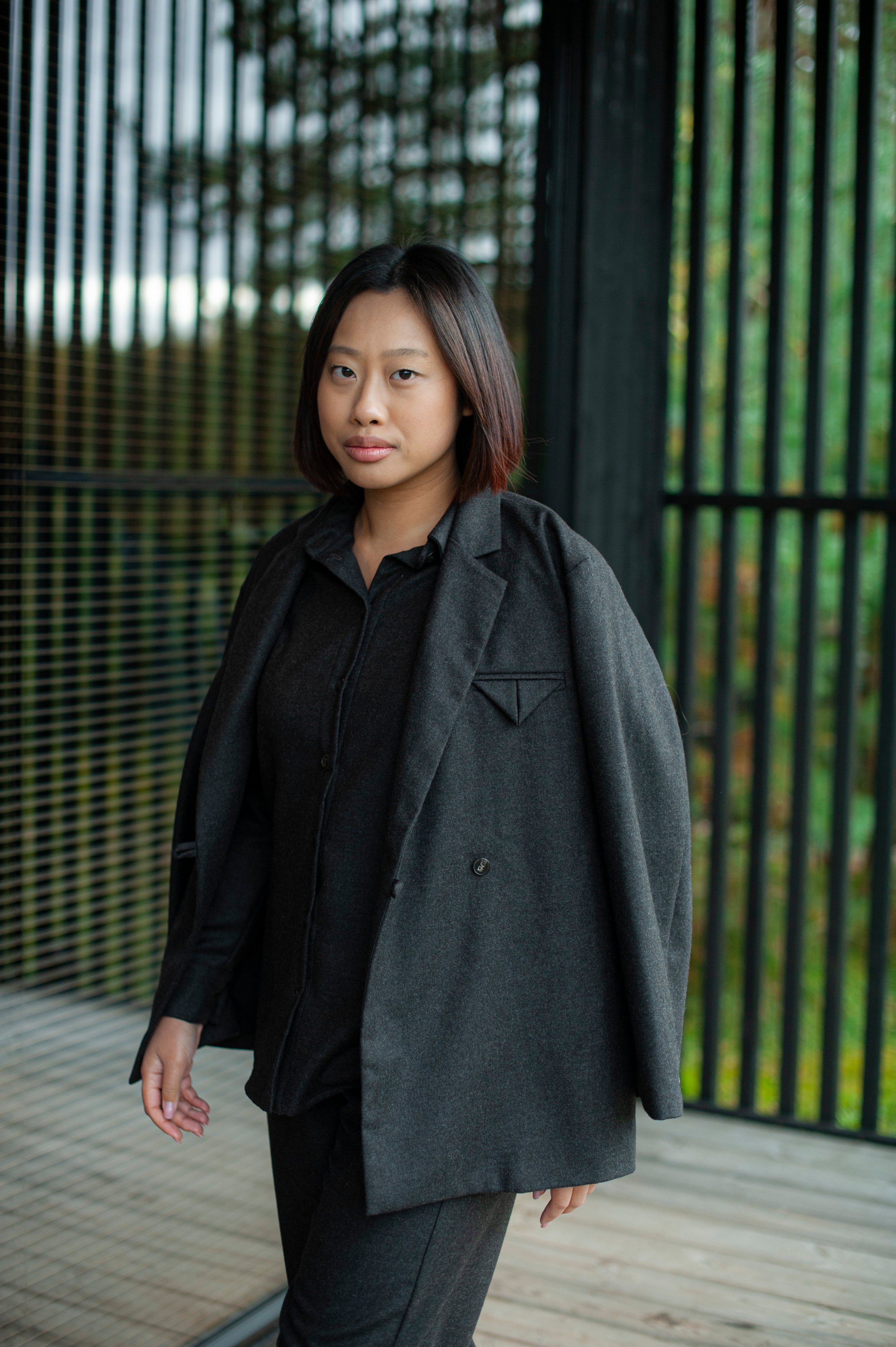 Women's  brown single-breasted boxy fit blazer paired with matching pants. 