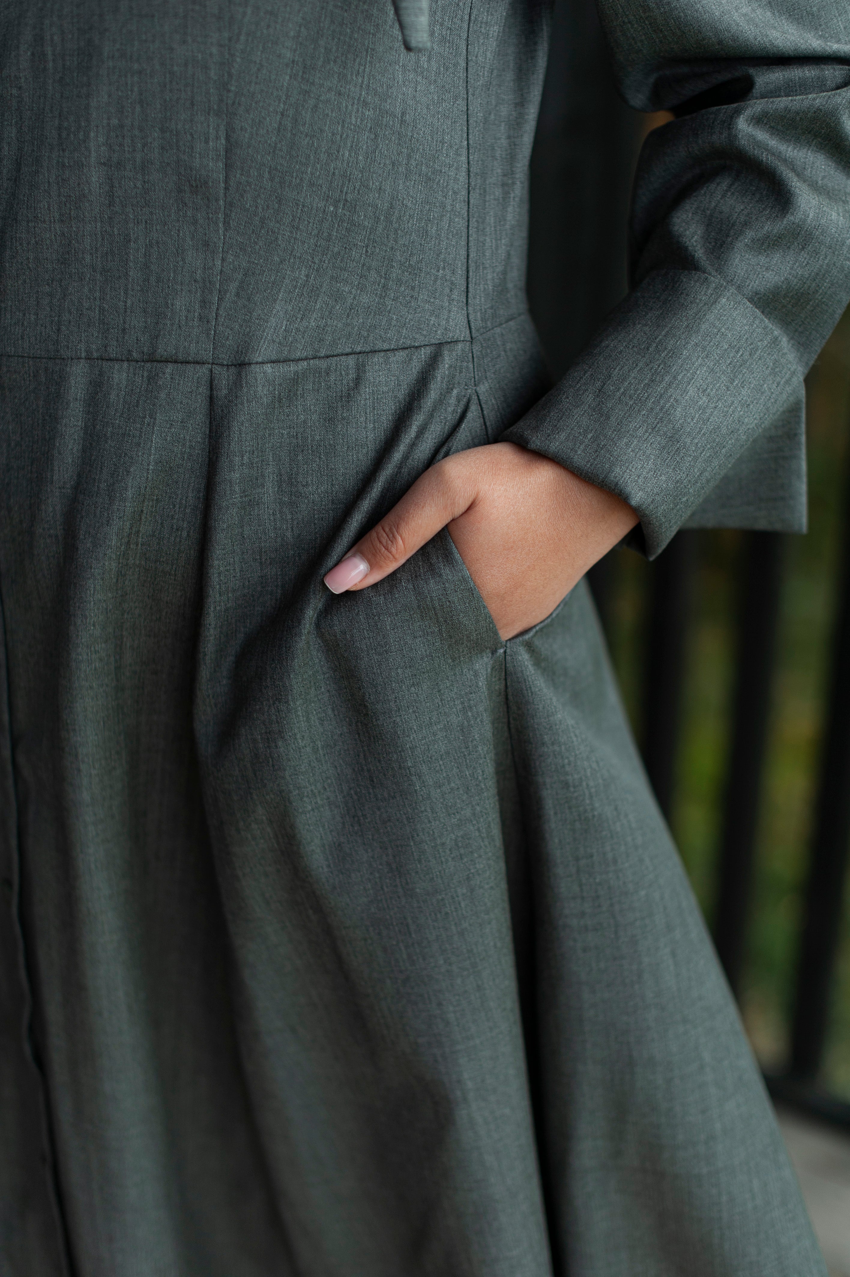 Inseam side pockets of a grey merino wool dress